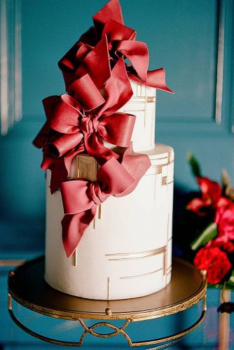 unique wedding cakes white with voluminous red bows lisa blume photography via instagram