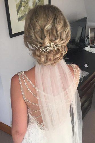 wedding hairstyles with veil on blonde bridal hair with low curly updo jojo_hicks_mua via instagram