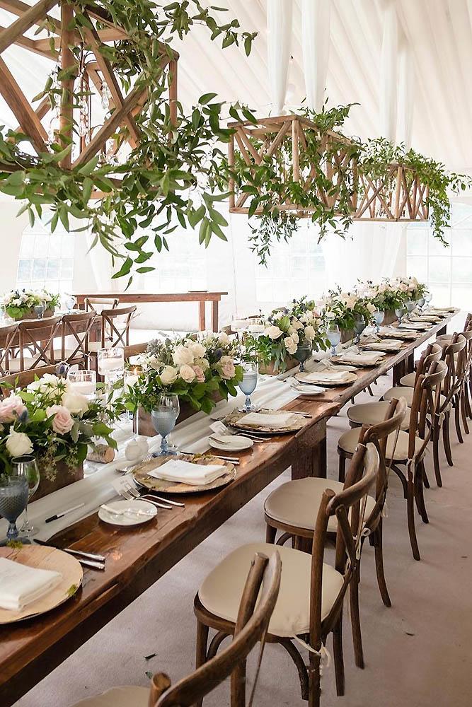 wedding tent reception rustic style decorated with suspended wood and greenery rowellphoto