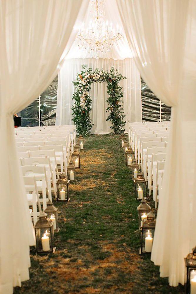 wedding tent romantic ceremony with lanterns candles aisle and greenery altar christinaloganevents