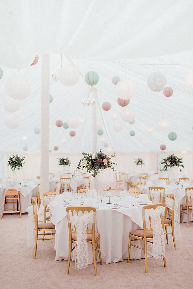 wedding tent round tables with white tablecloths and flowers kathryn hopkins photography