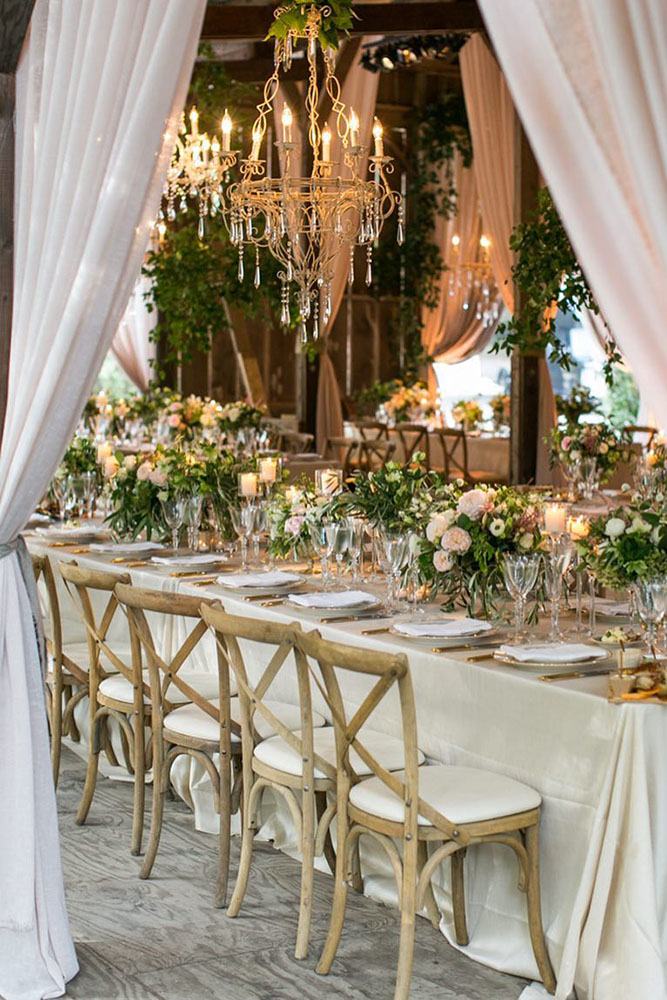 wedding tent table with golden chandelier with appliances and flowers samuel lippke studios