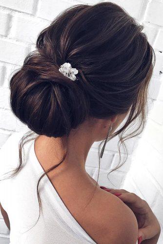 wedding updos for medium hair on black hair chignon bun with loose curls mpobedinskaya