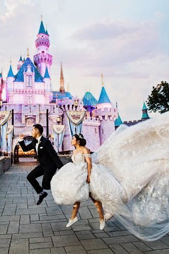 disney wedding funny couple jumping near disney castle