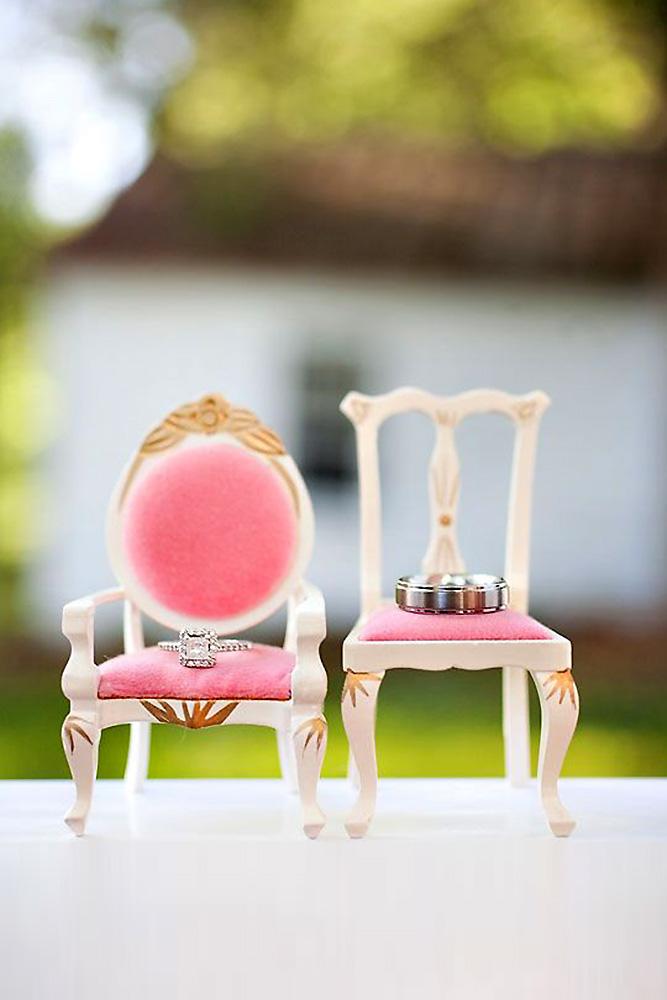 disney wedding rings on small pink chairs millie holloman photography