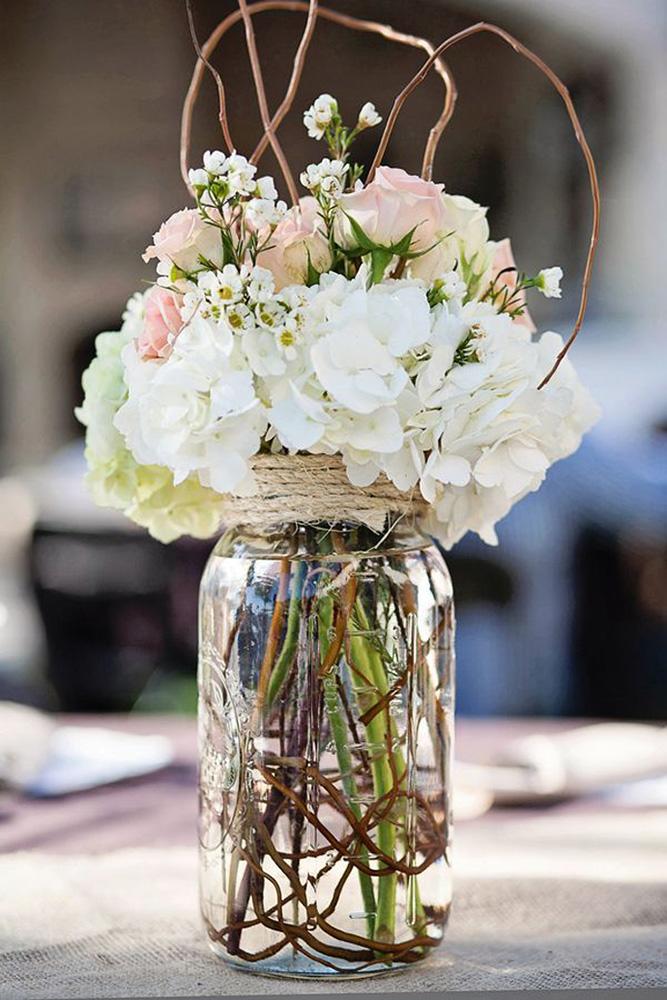 rustic wedding centerpieces white flowers and pink in jar with brunches caitlin skinner photography