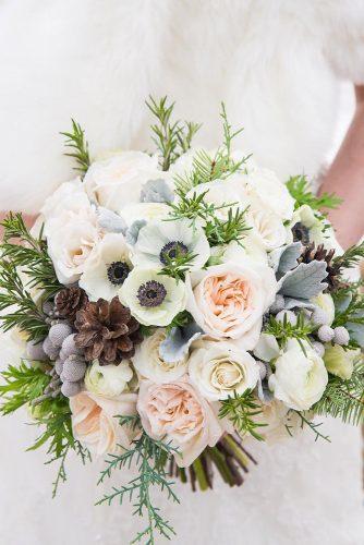 winter wedding bouquets white bouquet with cones and spruce branches calgary wedding photographer via instagram