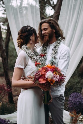 bride and groom with a bouquet near the altar lorena erre photography