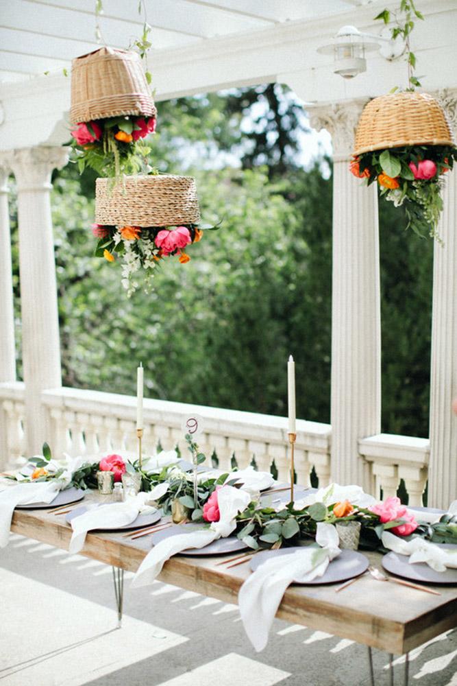 bohemian décor ideas over a wedding table hanging wicker baskets with flowers paige jones