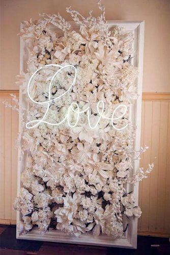 2019 wedding trends flower backdrop with neon sign bellabloomsfloral via instagram