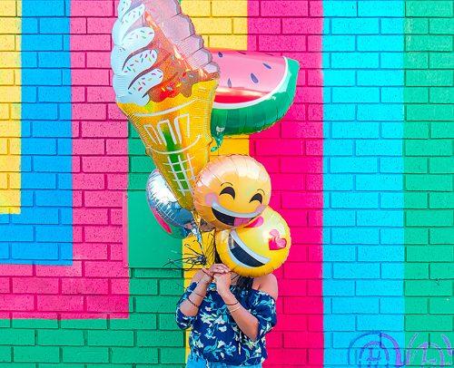 how to plan a bachelorette party happy girl with colorful balloons