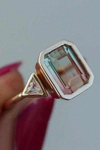 engagement ring trends radiant cut colored gemstone three stones