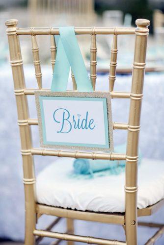 tiffany blue wedding decorations ribbons and bride sign decorate the table studio 11 weddings