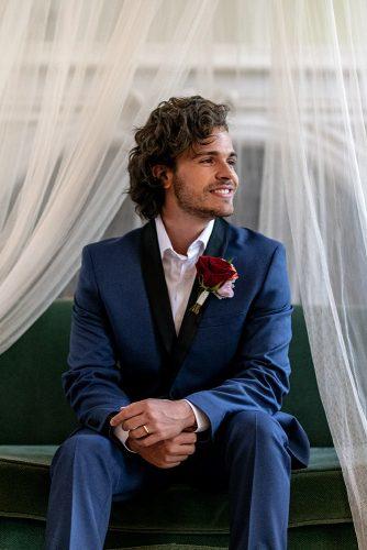 arabic wedding groom in blue suit with boutonniere red rose madi photograph