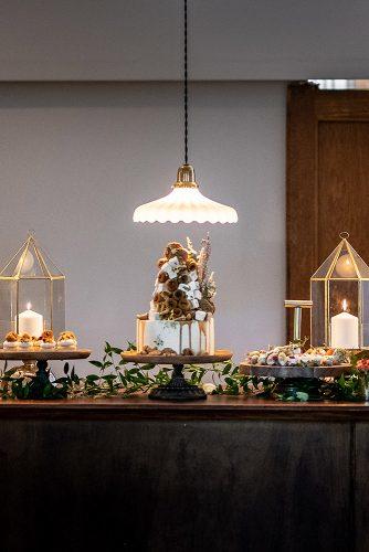 arabic wedding oriental dessert table with cake desserts candles and greenery madi photograph
