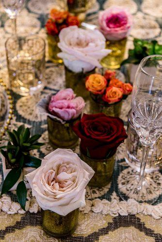 arabic wedding small vases with lonely roses on table madi photograph