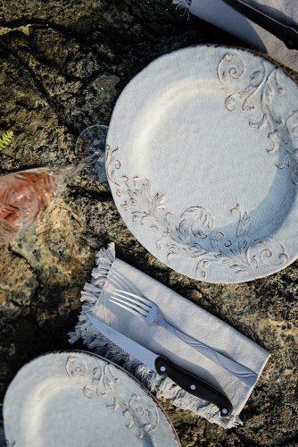 beach styled shoot wedding place settings on rocks with white dishes alexi