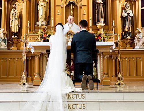 catholic wedding vows bride and groom at the wedding ceremony fiatphotography min