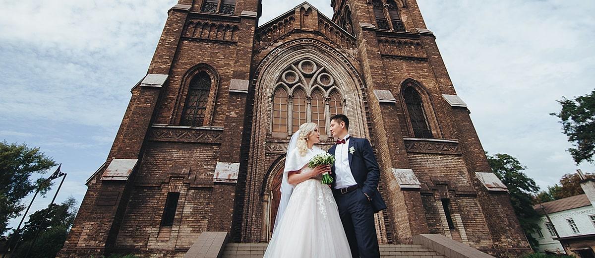 catholic wedding vows bride and groom near church min