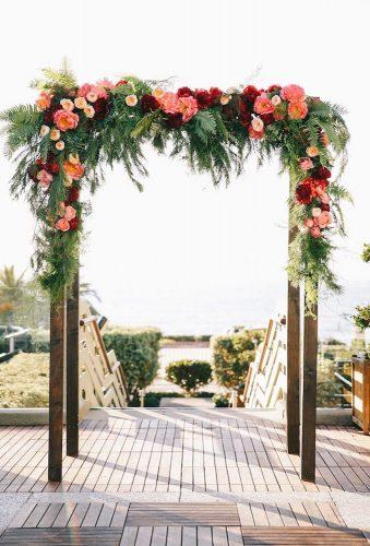 coral wedding decorations flower arch Brandon Kidd Photography