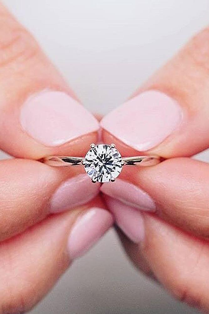 ring with two simple weding bands and a solitaire in between ring with two simple weding bands and a solitaire in between