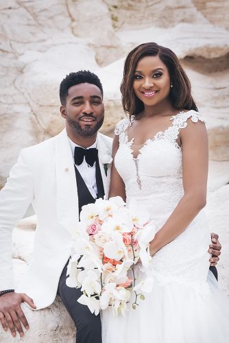 real wedding photography cindy glen bride with white cascading orchid bouquet and groom in black white suit are sitting stanlo photography