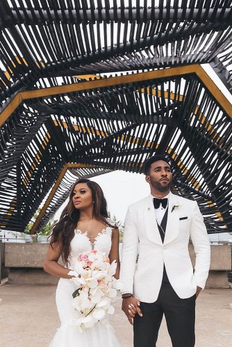 real wedding photography cindy glen photo bride with loose curls in lace dress with cascading orchid groom in white black suit stanlo photography