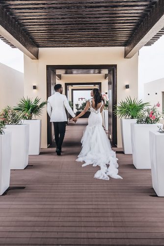 real wedding photography cindy glen photo from the back bride in lace dress groom in black white suit stanlo photography