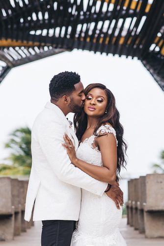 real wedding photography cindy glen photo outdoor bride with loose curls in lace dress groom in white black suit stanlo photography
