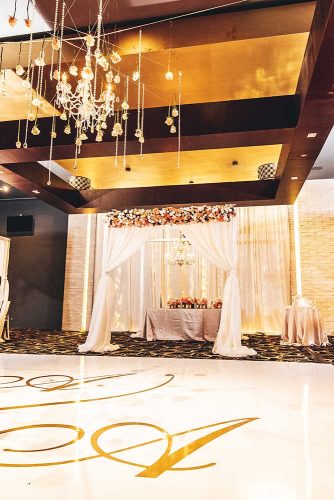real wedding photography cindy glen wedding reception hall with flower arch stanlo photography