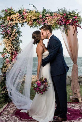 dusty rose wedding bridal arch with flowers and cloth jukneipp