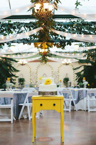 mustard wedding bright small table with ruffled white cake with flower urban safari