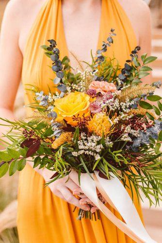 mustard wedding bright wedding bouquet with roses greenery and sage blue leaves brooke michelle photography