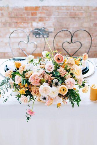 mustard wedding coloreul flowers and candles on table annaperevertaylo