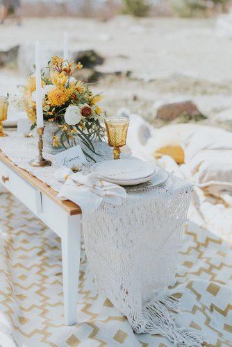 mustard wedding small boho outdoor table with macrame tablecloth flower centerpiece white candles eclectic glasses courtney elizabeth media