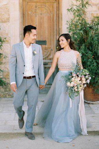 wedding colors 2019 groom in grey suit and bride with half up half down hairstyle in skirt katiegrantphoto