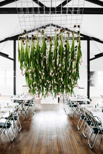spring wedding decor hanging tulips ceremony backdrop brooke holm