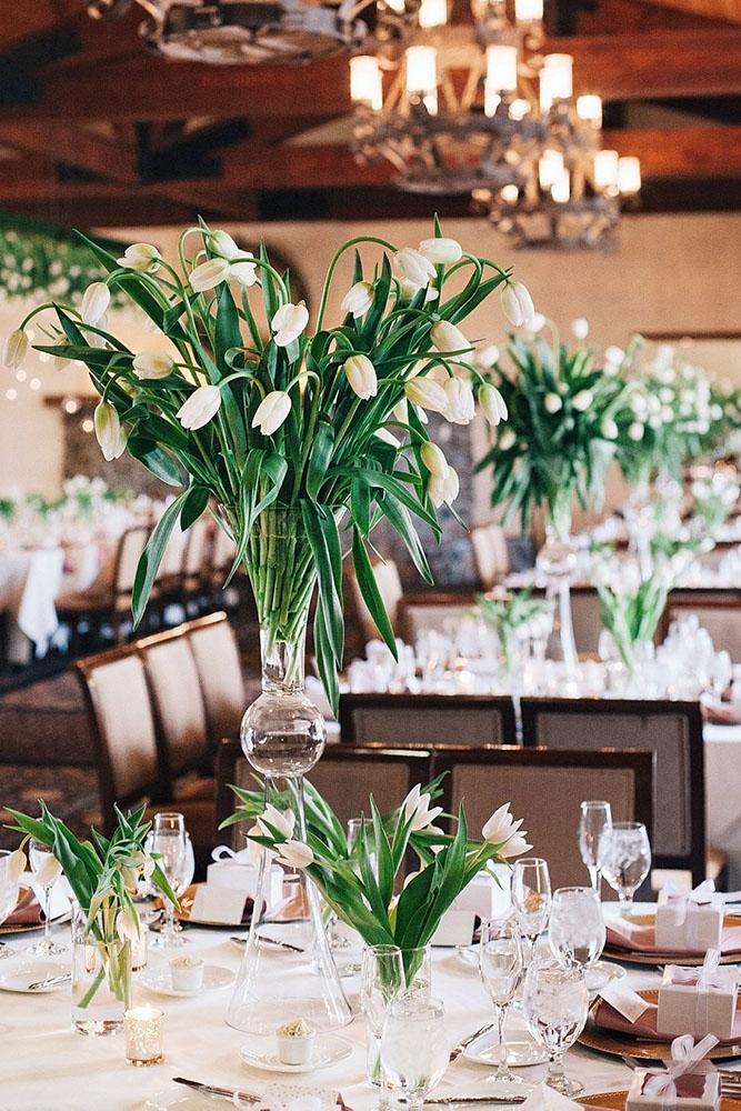 spring wedding decor tall flower centerpiece in glass vace with white tulips annaperevertaylo