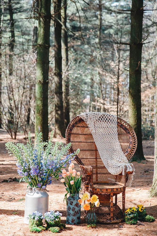 bohemian wedding decorations bohemian chair surrounded by vases with flowers maria bryzhko
