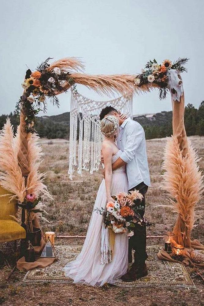 bohemian wedding decorations outdoor arch with flowers pampas grass and macrame kim villa photography