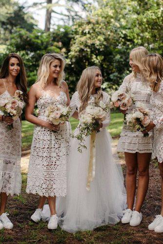 bohemian wedding look boho bride with her bridesmaids in short white lace dresses and sneakers mitch pohl