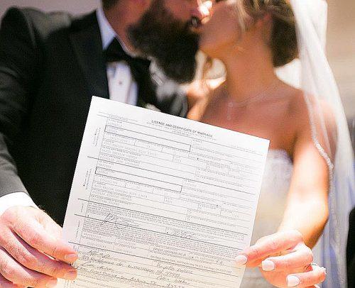 how to change your name newlyweds kissing holding marriage license