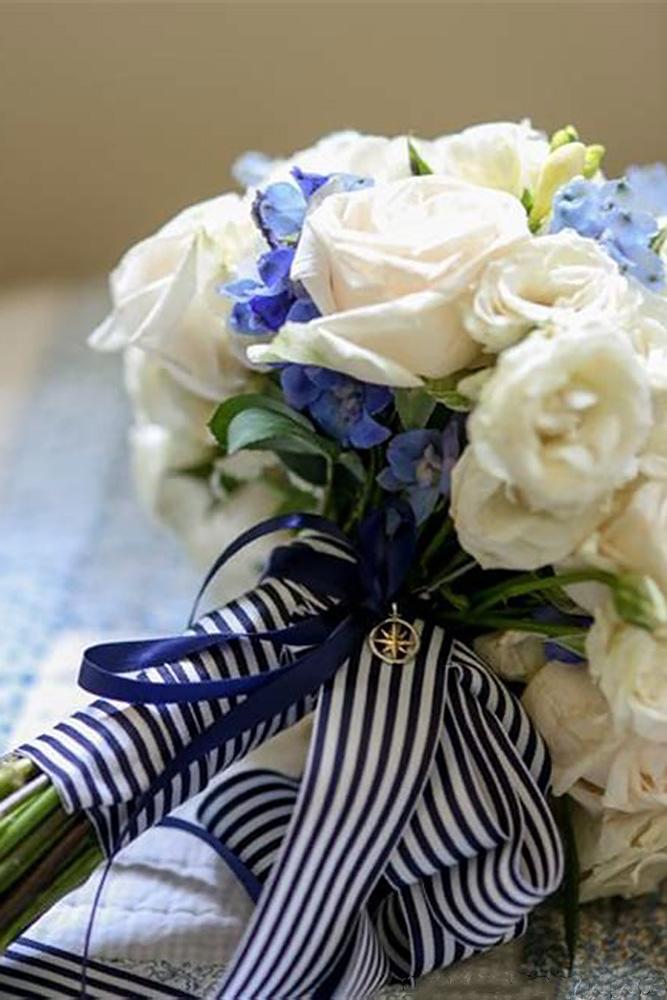 nautical wedding bouquet with white and blue flowers with stripes ribbons rodeoandco