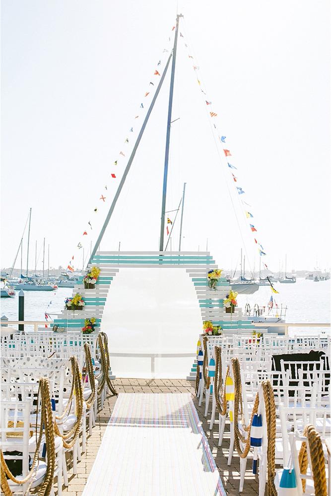 nautical wedding bright yellow blue wooden arch ropes in the aisle sargeant creative