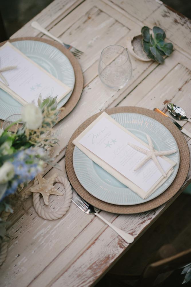 nautical wedding table seatind with sea stars ropes and blue plates lauren rae photography