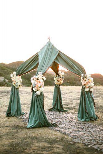 sage green wedding cloth arch with flowers outdoor ceremony aaron delesie