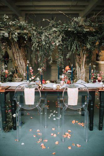 sage green wedding recetion indoog with tall tree centerpieces and candles mle pictures
