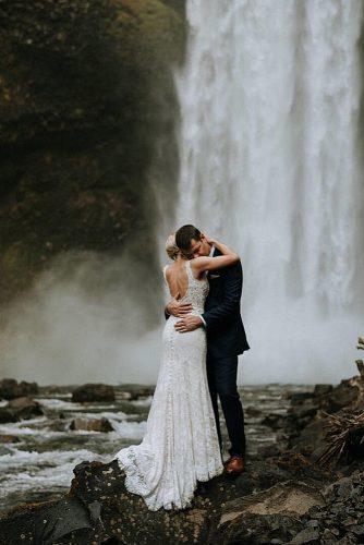 wedding photographers amazing photo of newlyweds near waterfall sararogersphotography