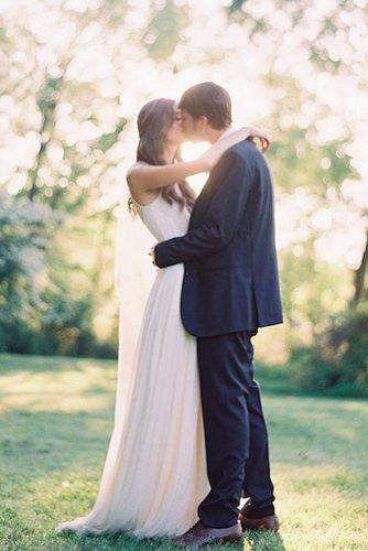 wedding photographers romantic kiss newlyweds at the nature ryleehitchner