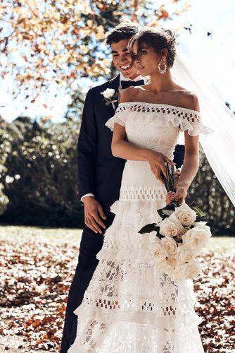 bohemian wedding look stylish couple bride with white bouquet in lace dress jayde creative co
